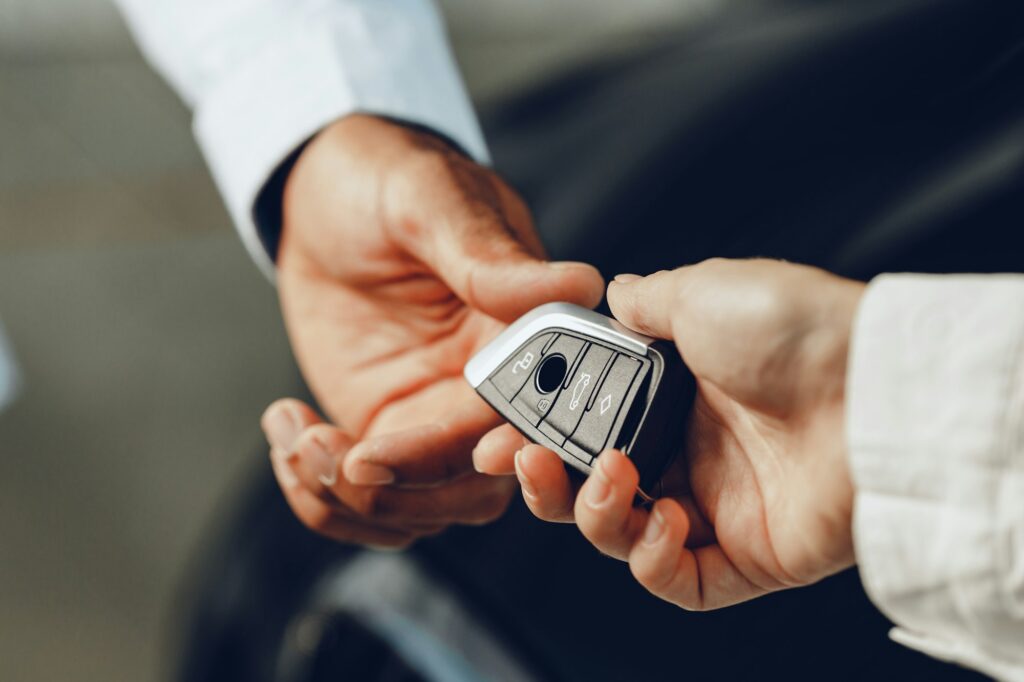 Car salesperson giving keys to a client close up, Car Key Replacement Orlando