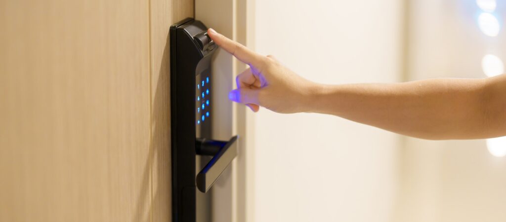 Hand using fingerprint scan for smart digital door lock